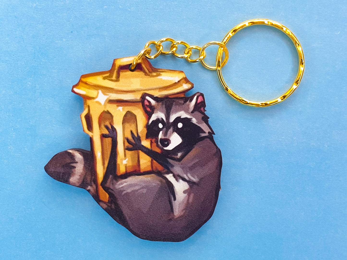 Wooden Raccoon in Gold Trashcan Keychain