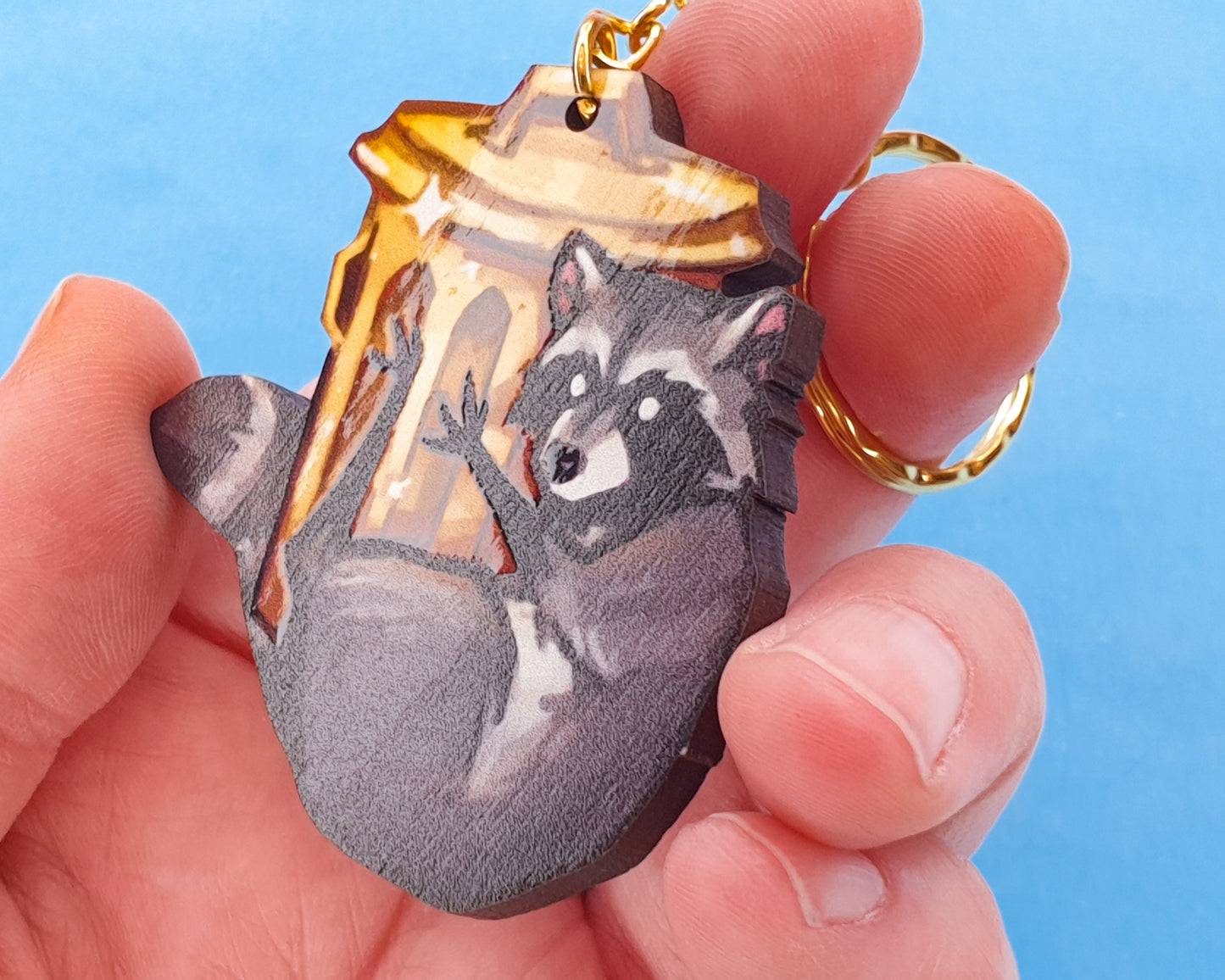 Wooden Raccoon in Gold Trashcan Keychain